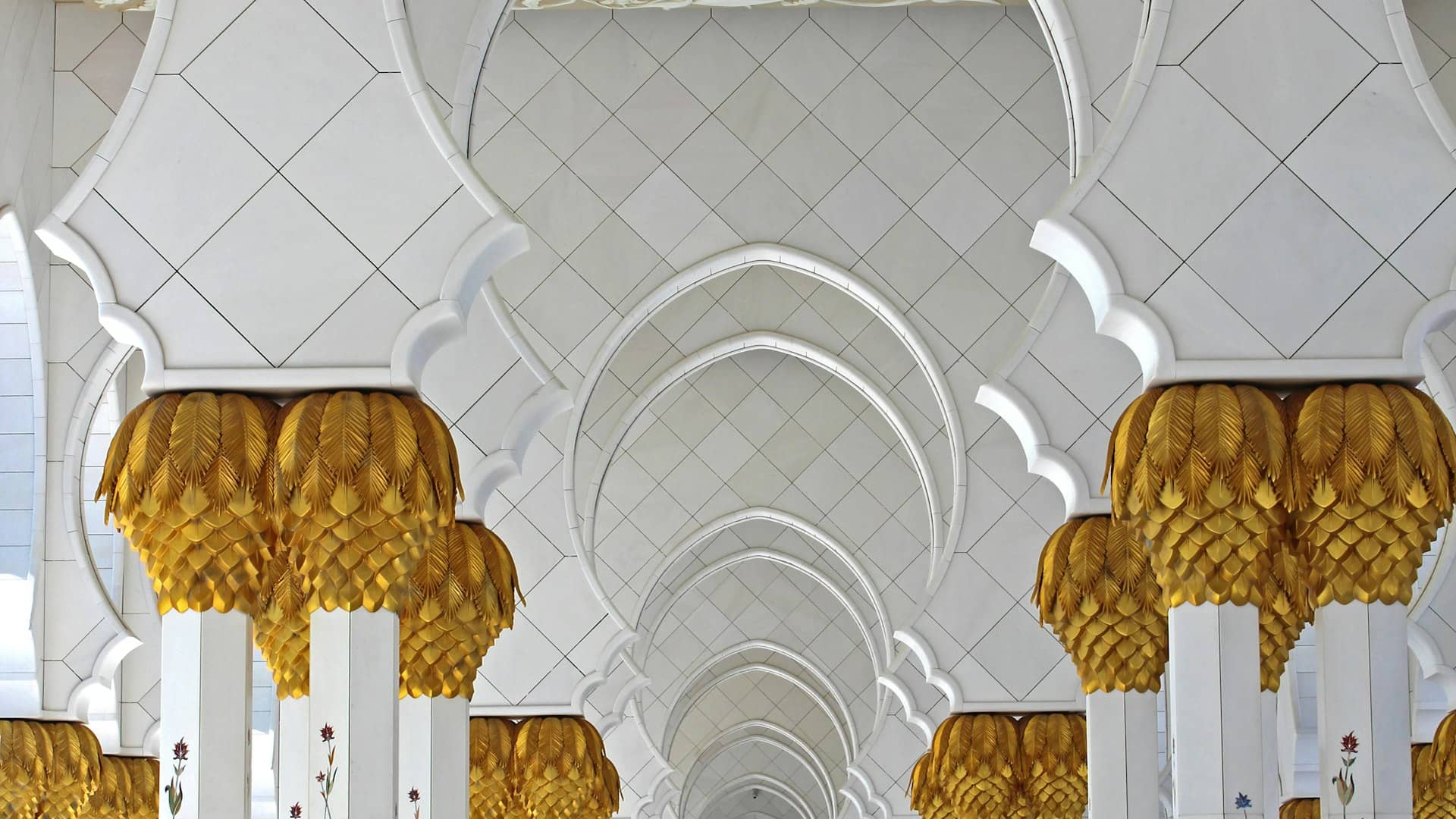 Grand mosque colonnade with golden pillar capitals